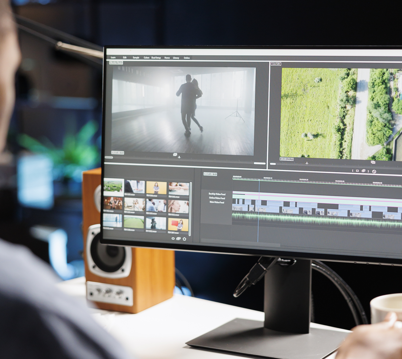 Video editor colour grading corporate video footage in a post-production suite
